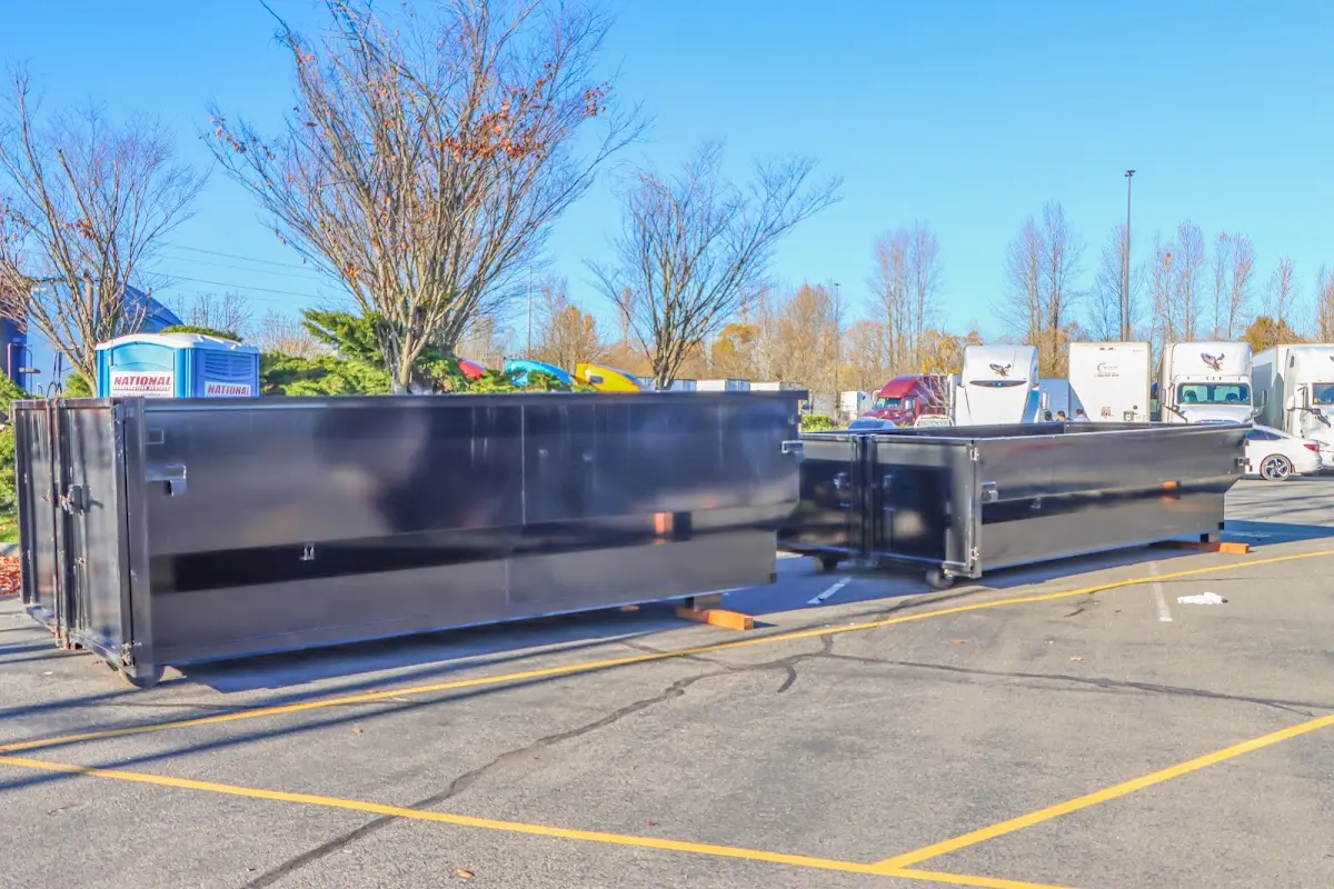 Professional dumpster rental service with roll-off container on residential driveway in Spring